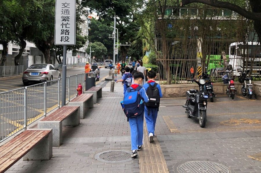 Children leave a school in the Shekou area of Shenzhen, Guangdong province, China, 20 April 2021. (David Kirton/Reuters)
