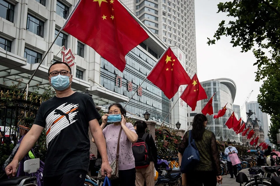 People walk along a street in Wuhan, Hubei, China on 29 September 2020. (STR/AFP)