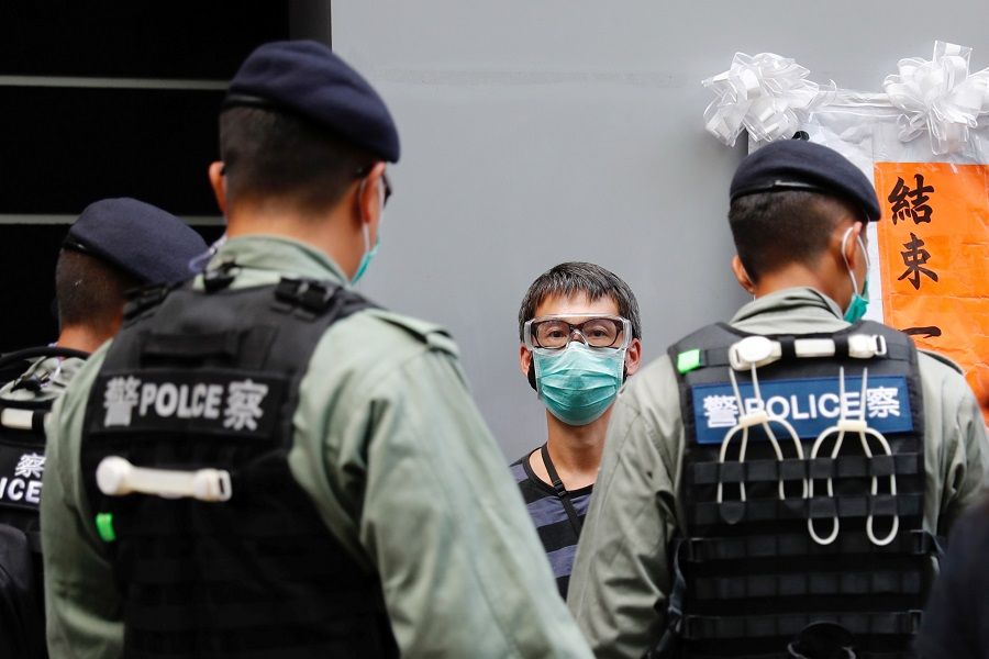 Police search a pro-democracy protester during a demonstration on the anniversary of Hong Kong's handover to China in Hong Kong. (Tyrone Siu/Reuters)