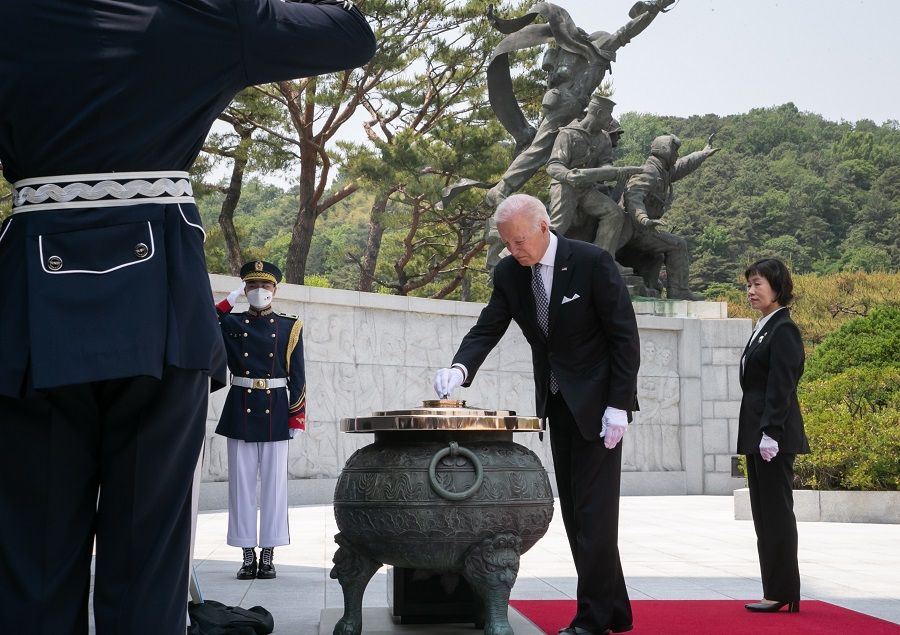 US President Joe Biden releases incense into a large ceremonial urn during a wreath-laying ceremony during his visit to the National Cemetery in Seoul, South Korea, on 21 May 2022. (Lee Yong-ho/EyePress/Bloomberg)