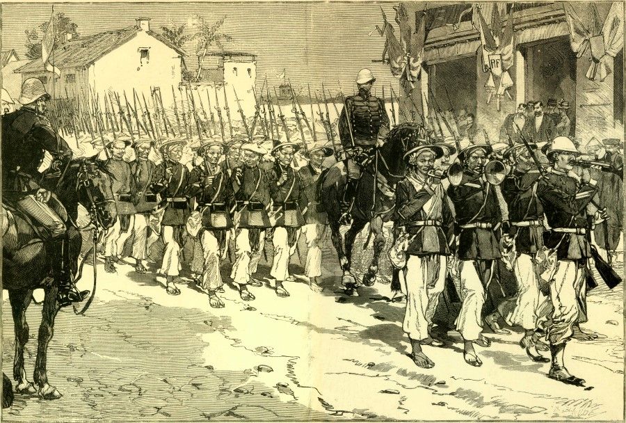 An image in French publication Le Monde illustré, 1884, showing local mercenary soldiers recruited by the French army, marching in line on the streets of Hanoi.