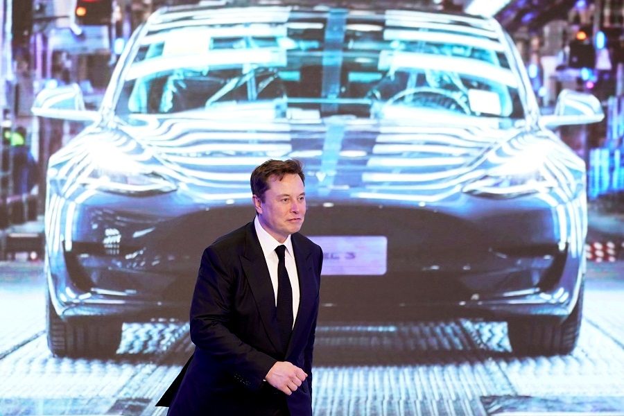 Tesla CEO Elon Musk walks next to a screen showing an image of a Tesla Model 3 vehicle during an opening ceremony for Tesla's China-made Model Y programme in Shanghai, China, 7 January 2020. (Aly Song/File Photo/File Photo/Reuters)