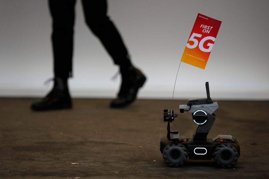 A 5G flag carried by a robot is pictured during the 10th Global mobile broadband forum hosted by Huawei in Zurich on October 15, 2019. Huawei announced on October 16, 2019 that it has passed the 400,000 5G antennas mark, the fifth generation of mobile phones, in the world with 56 operators who have already started to roll out the new mobile network. (Stefan Wermuth/AFP)