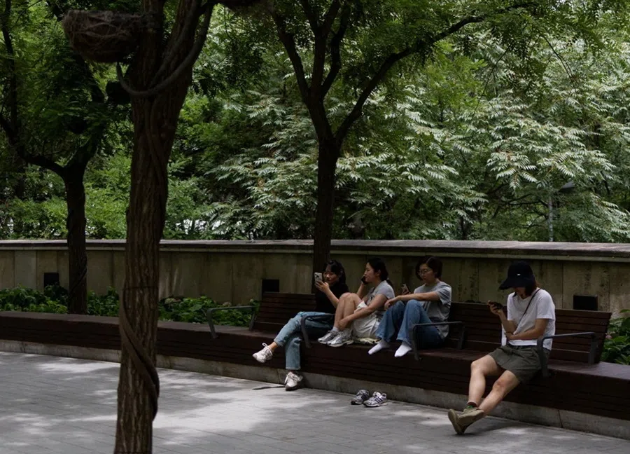 People rest in a park in Beijing, China, 26 June 2026.