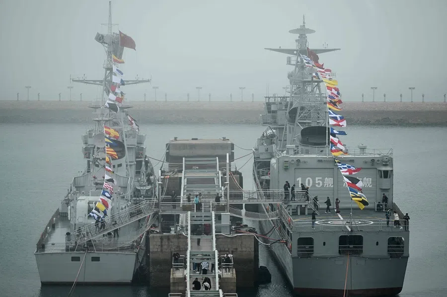This picture taken during a media tour organised by the Chinese People’s Liberation Army Navy (PLAN) to mark its 75th founding anniversary, shows the Chinese Navy Jinan destroyer (R) at the PLA Naval Museum in Qingdao, China’s Shandong province, on 23 April 2024.