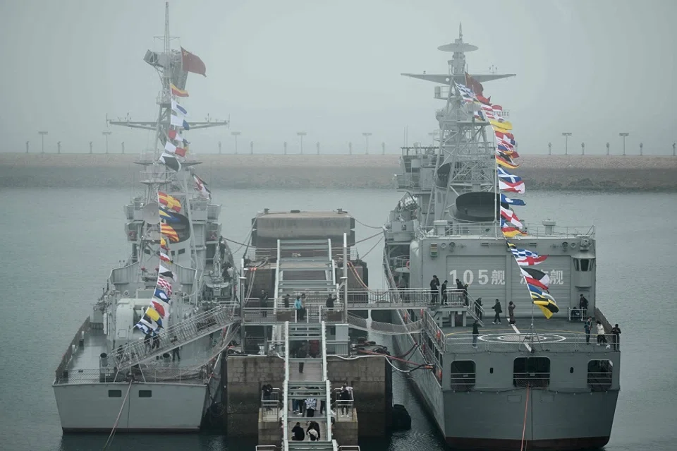 This picture taken during a media tour organised by the Chinese People’s Liberation Army Navy (PLAN) to mark its 75th founding anniversary, shows the Chinese Navy Jinan destroyer (R) at the PLA Naval Museum in Qingdao, China’s Shandong province, on 23 April 2024. (Wang Zhao/AFP)