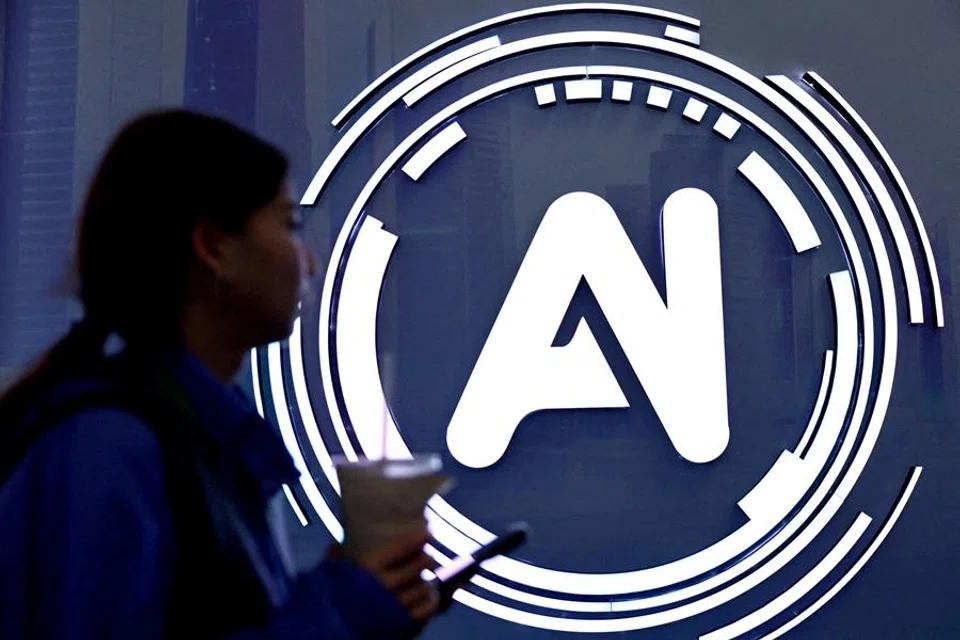 A woman walks past a sign reading "AI" at the World Internet Conference in Wuzhen, Tongxiang city, Zhejiang province, China, on 8 November 2025. (Tingshu Wang/Reuters)