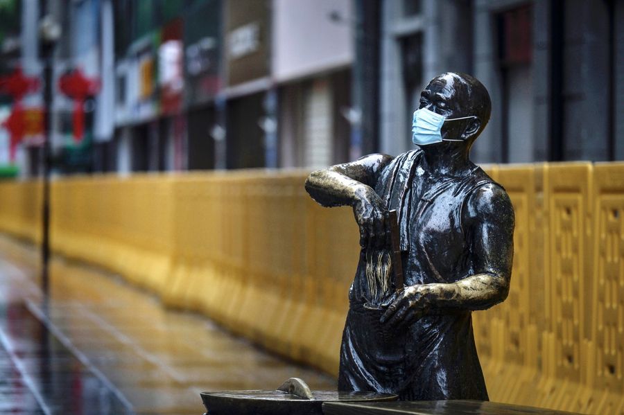 This photo taken on 28 February 2020 shows a statue with a face mask on in Wuhan. (STR/AFP)