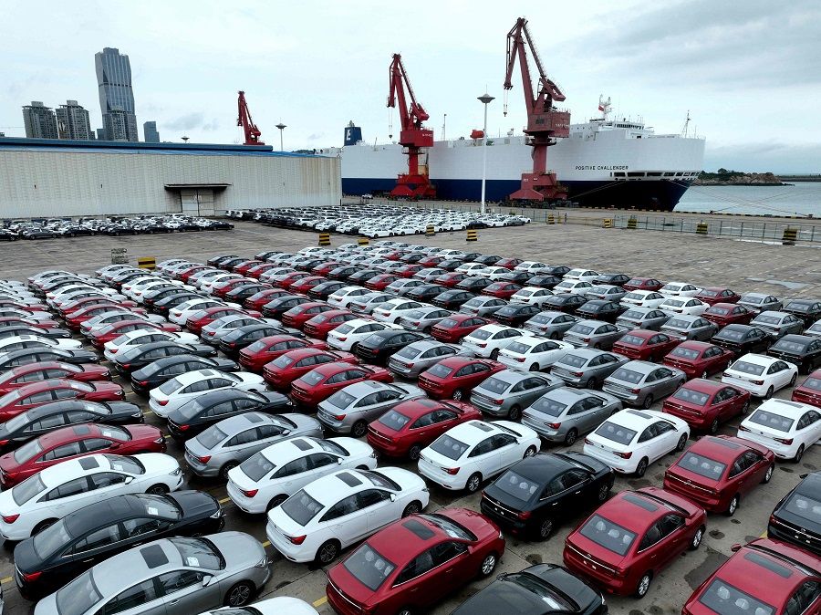 Cars waiting to be loaded onto a ship at Lianyungang port, in Jiangsu province, China, on 13 July 2023. (AFP)