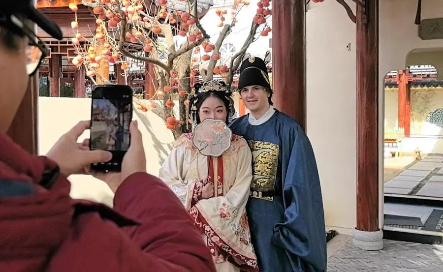 Xiaozhou takes a photograph in traditional Chinese costume with her Dutch boyfriend, Tim, before dining at Yan Wai Yan.
