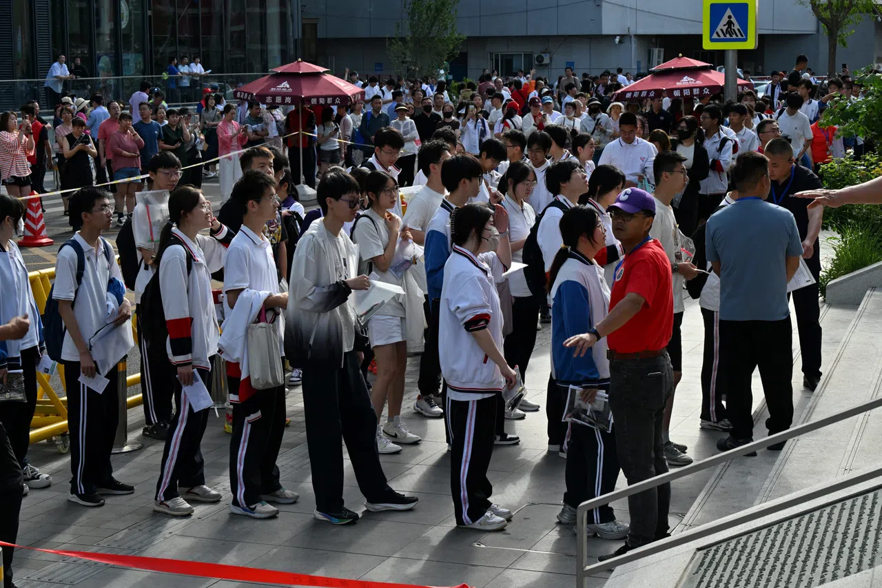 Students queue to enter a school during China's National College Entrance Examination (NCEE), known as gaokao, outside a high school in Beijing on 7 June 2025.
