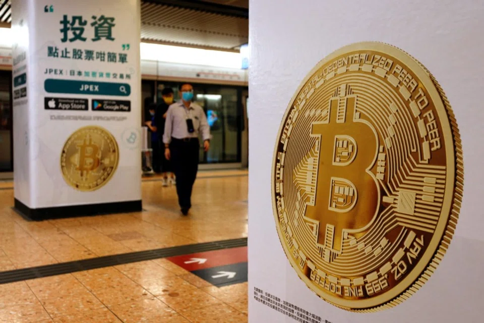 Advertisements for crypto exchange show a Bitcoin symbol at Mass Transit Railway (MTR) station, in Hong Kong, China, 27 October 2021. (Tyrone Siu/Reuters)