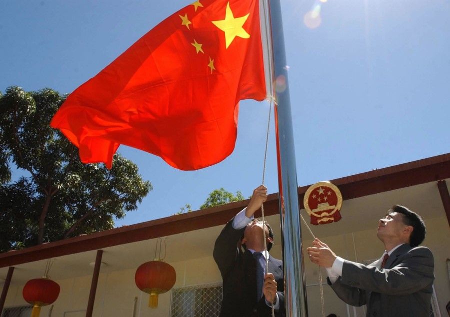 The Chinese flag is raised in front of the Chinese Embassy in Dili, capital of Timor-Leste, May 20, 2002. China was the first country in the world to establish diplomatic relations with Timor-Leste. (Xinhua)