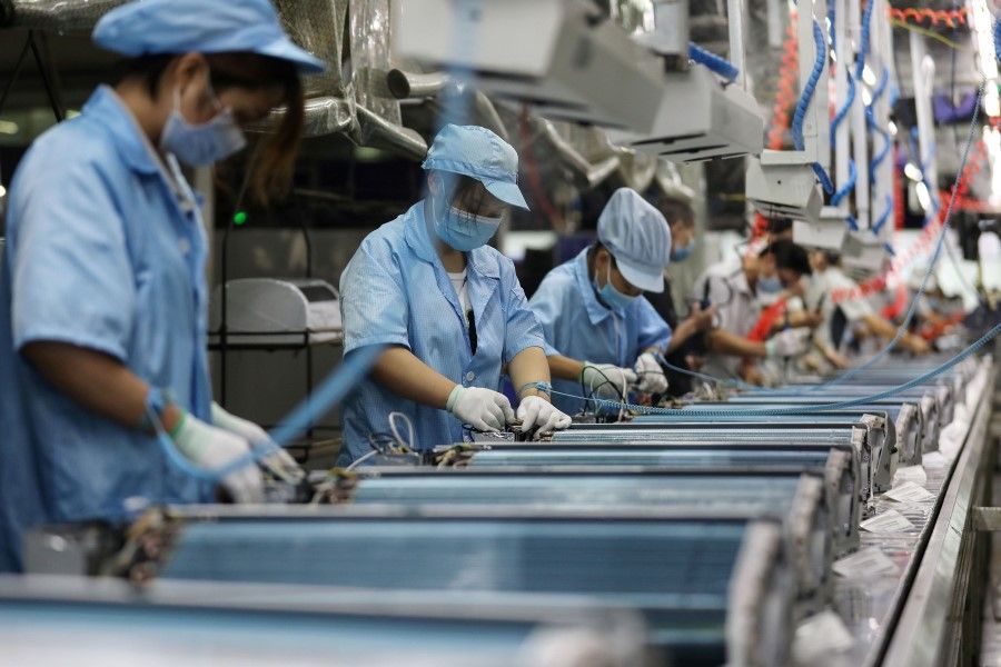 Employees work on an air conditioner production line at a Haier factory in Wuhan, in China's central Hubei province on 10 September 2020. (STR/AFP)