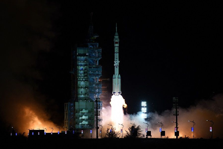 A Long March-2F carrier rocket, carrying the Shenzhou-13 spacecraft with the second crew of three astronauts to China's new space station, lifts off from the Jiuquan Satellite Launch Centre in the Gobi desert in China, on 16 October 2021. (STR/AFP)
