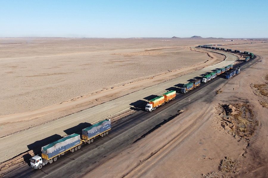 This aerial picture taken on 16 October 2021 shows trucks loaded with coal waiting near Gants Mod port at the Chinese border with Gashuun Sukhait, in Umnugovi province, in Mongolia. (Uugansukh Byamba/AFP)