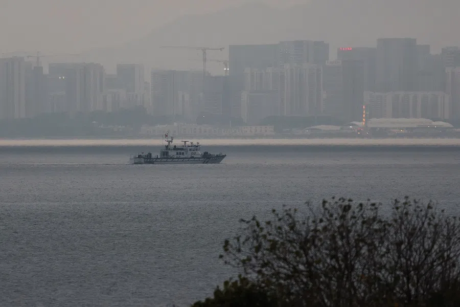 A fishing boat can be seen between Kinmen and Xiamen in China in Kinmen, Taiwan, on 20 February 2024. (Ann Wang/Reuters)