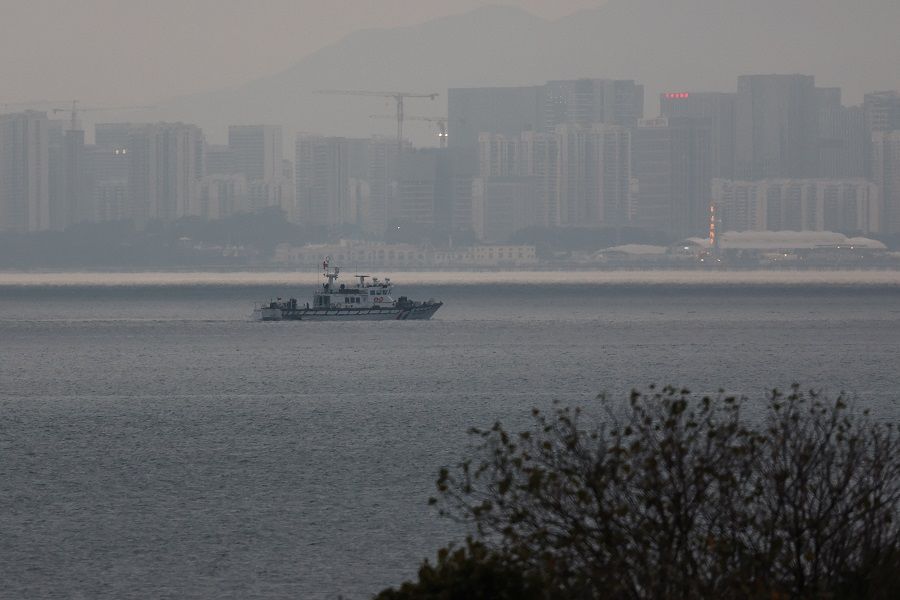A fishing boat can be seen between Kinmen and Xiamen in China in Kinmen, Taiwan, on 20 February 2024. (Ann Wang/Reuters)
