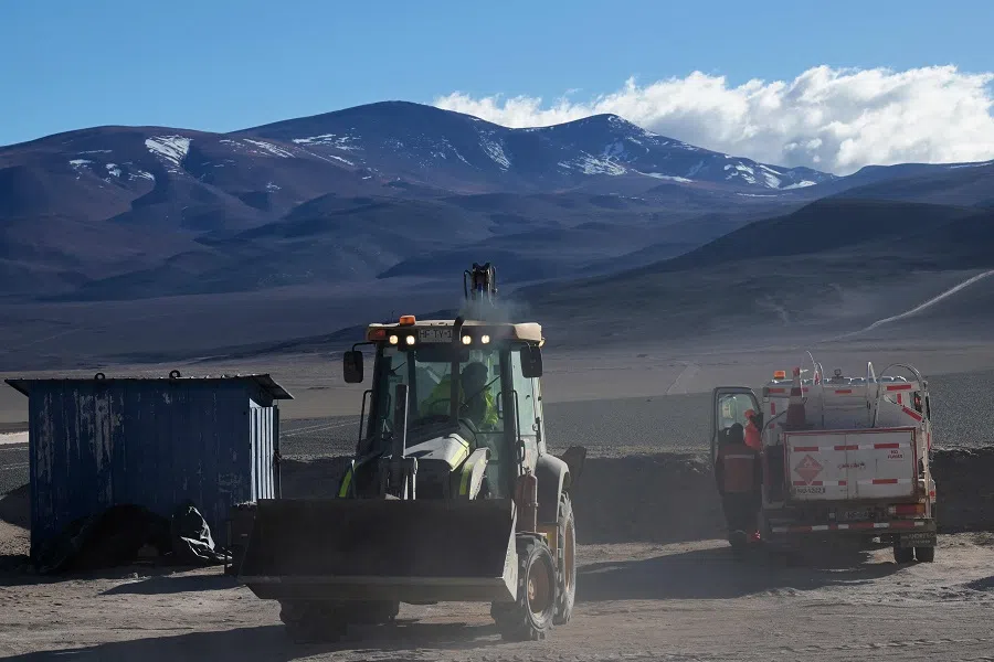 Workers operate machinery at the Aguilar salt flat, located in the Andean mountain range of the Atacama Region, Chile, on 16 May 2024. (Rodrigo Arangua/AFP)