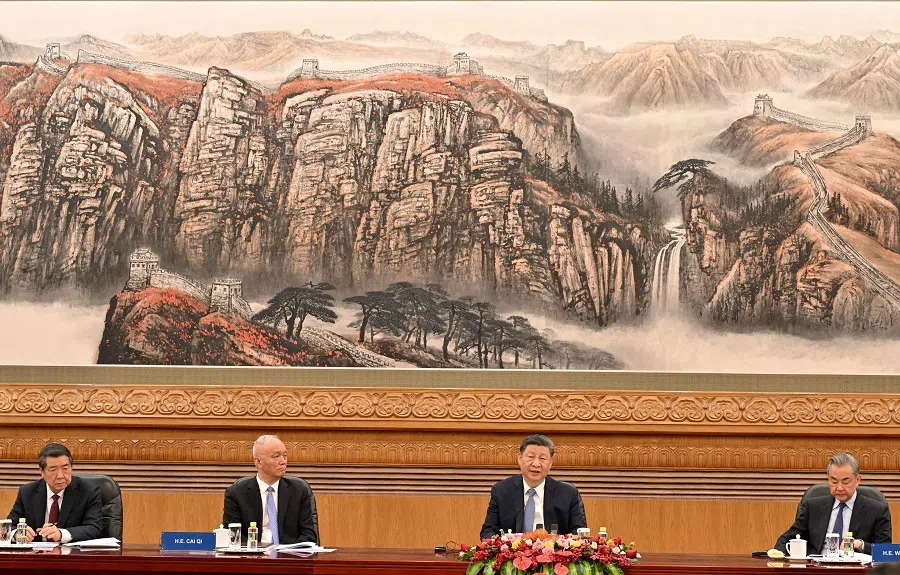 China’s President Xi Jinping (second from right) speaks next to Foreign Minister Wang Yi (first from right), Cai Qi (second from left), top ranking member of the Communist Party, and Vice-Premier He Lifeng (left) during a meeting with a group of foreign executives at the Great Hall of the People in Beijing, China, on 28 March 2025. (Adek Berry/AFP)