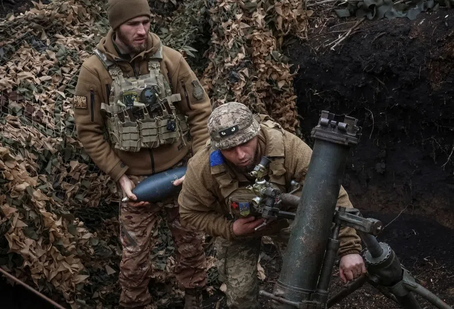 Ukrainian servicemen of the 28th Separate Mechanized Brigade fire a 120-mm mortar towards Russian troops at a frontline, amid Russia's attack on Ukraine, near the town of Bakhmut, Ukraine, on 15 March 2024. (Oleksandr Ratushniak/Reuters)