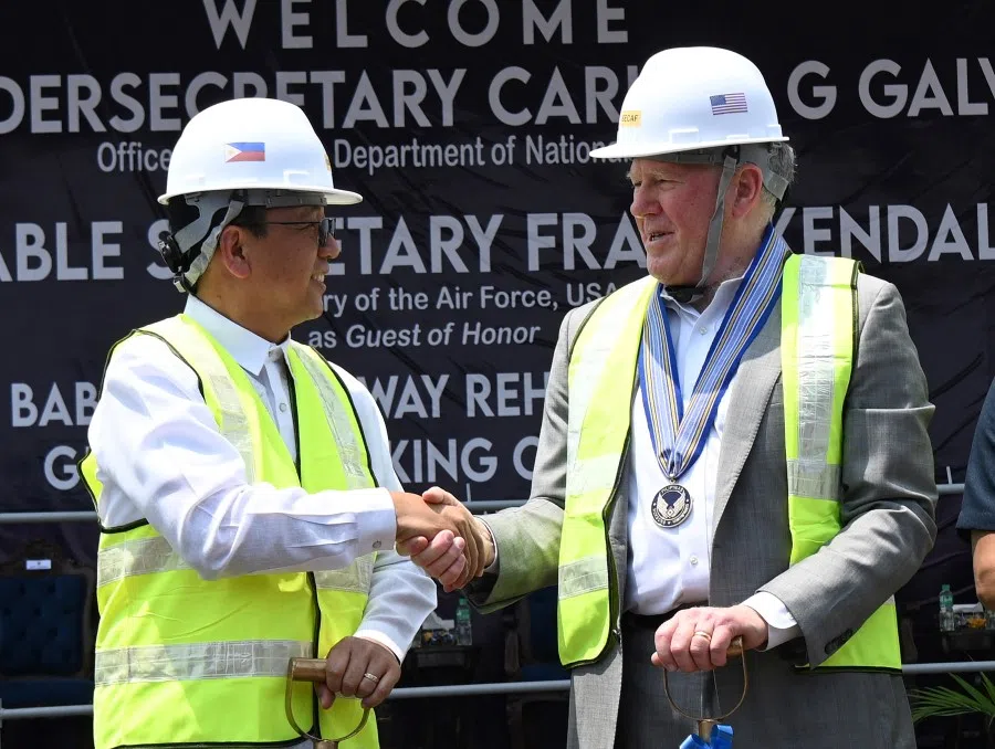 Philippines defence chief Carlito Galvez Jr and US Air Force Secretary Frank Kendall shake hands during the groundbreaking ceremony for an airstrip extension and rehabilitation project under the Enhanced Defense Cooperation Agreement (EDCA) agreement, at Basa Air Base in Pampanga, Philippines, 20 March 2023. (Ted Aljibe/Pool via Reuters)
