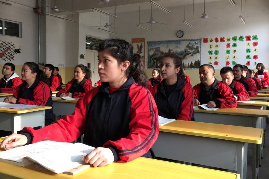 Residents at the Kashgar city vocational educational training centre attend a Chinese lesson during a government organised visit in Kashgar, Xinjiang Uighur Autonomous Region, China, 4 January 2019. (Ben Blanchard/Reuters)