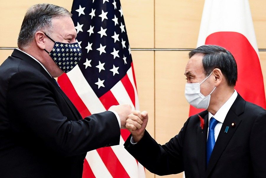 Japan's Prime Minister Yoshihide Suga and U.S. Secretary of State Mike Pompeo greet prior to their meeting at the prime minister's office in Tokyo, 6 October 2020. (Charly Triballeau/Pool via REUTERS)