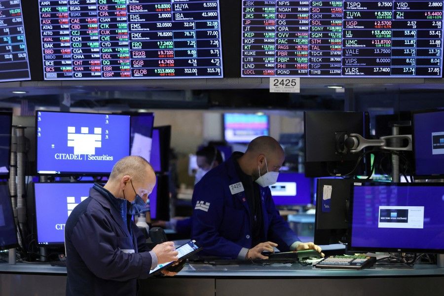 Traders work on the trading floor at the New York Stock Exchange (NYSE) in Manhattan, New York City, US, 28 December 2021. (Andrew Kelly/Reuters)