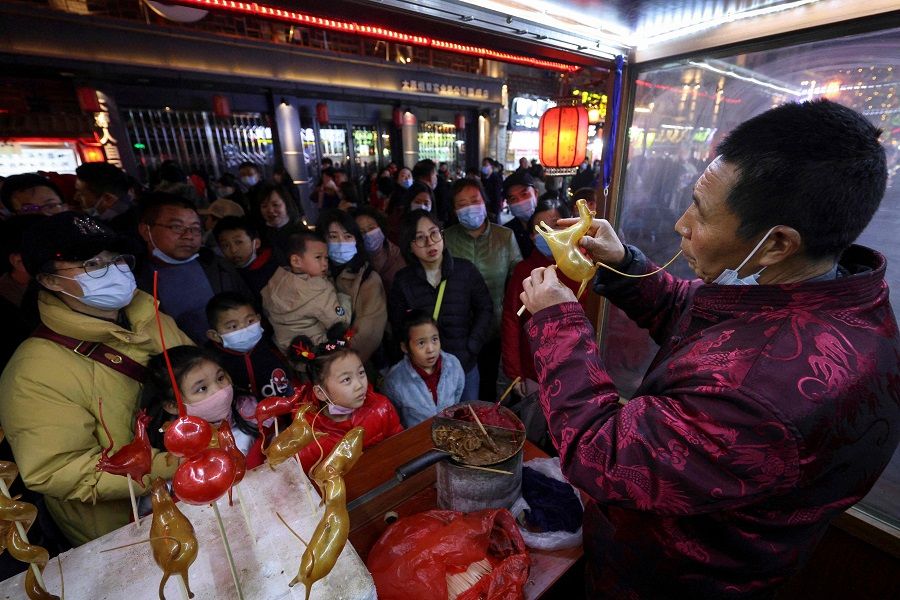 A man blows candy into various animal shapes in front of customers during the Lantern Festival, which marks the end of the Lunar New Year celebrations in Taiyuan, Shanxi province, China, on 26 February 2021. (STR/AFP)