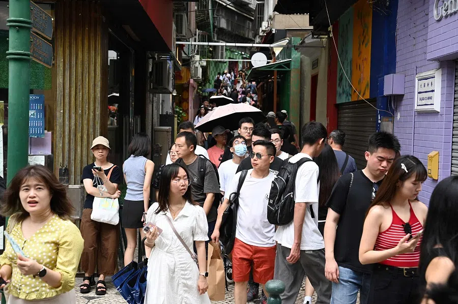 Large crowds of people walk through the historical centre of Macau, China, on 3 October 2023. (Peter Parks/AFP)