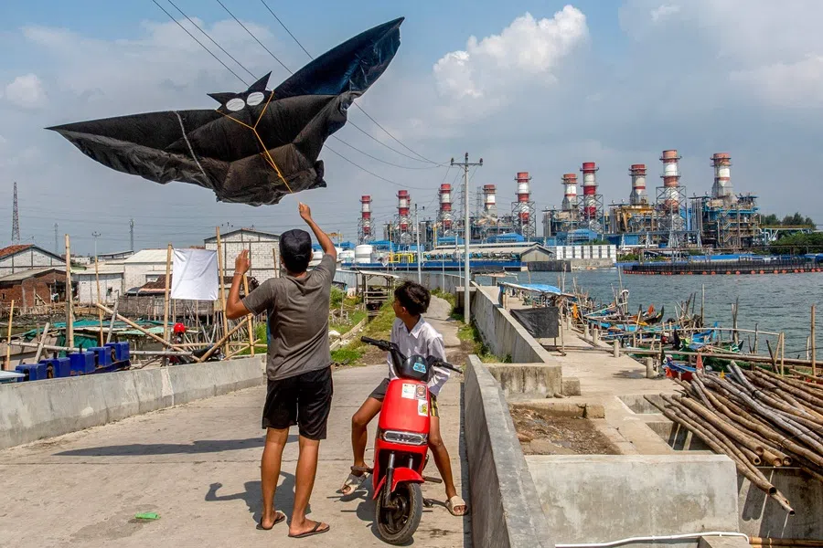 Children fly a kite as they play along a seawall in the coastal village of Tambaklorok, in Semarang, Central Java, Indonesia, on 17 June 2025. (Devi Rahman/AFP)