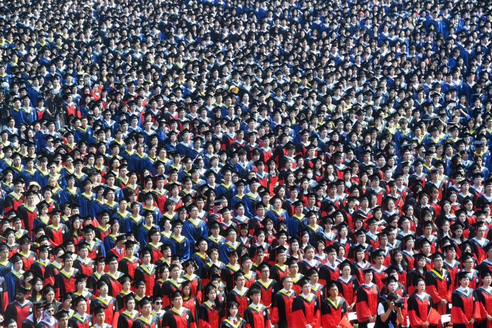 Graduates of Wuhan University attend the graduation ceremony in Wuhan, in China's central Hubei province on 20 June 2023. (AFP)