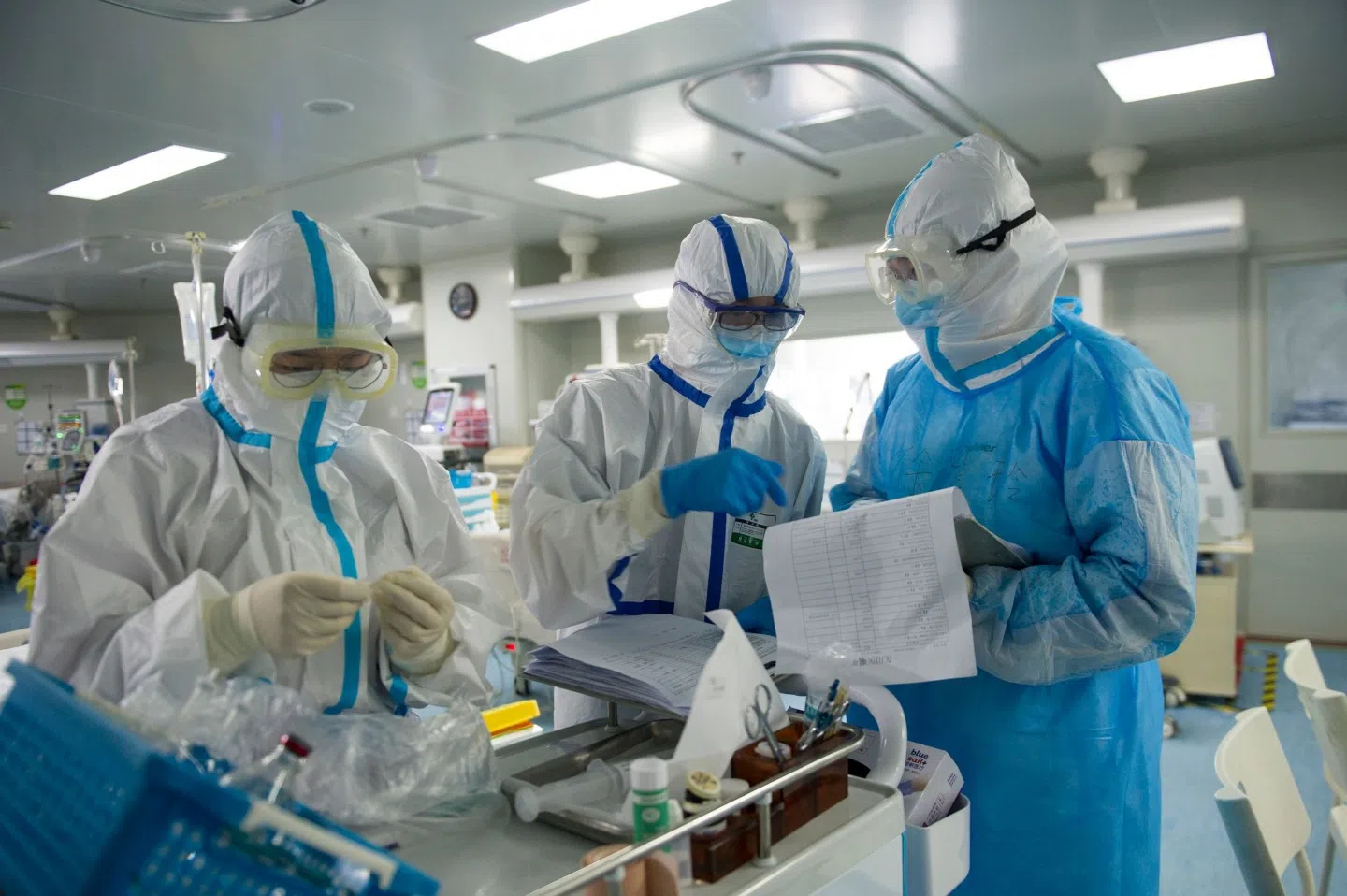 This photo taken on 22 February 2020 shows medical staff checking notes in an intensive care unit treating Covid-19 coronavirus patients at a hospital in Wuhan. (STR/AFP)