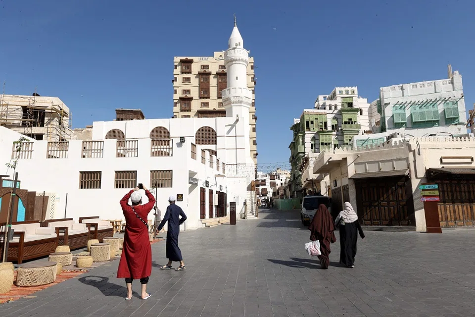 A picture taken on 18 January 2024 shows people on a street in Jeddah's oldest neighbourhood, known as Al-Balad, in Saudi Arabia. (AFP)