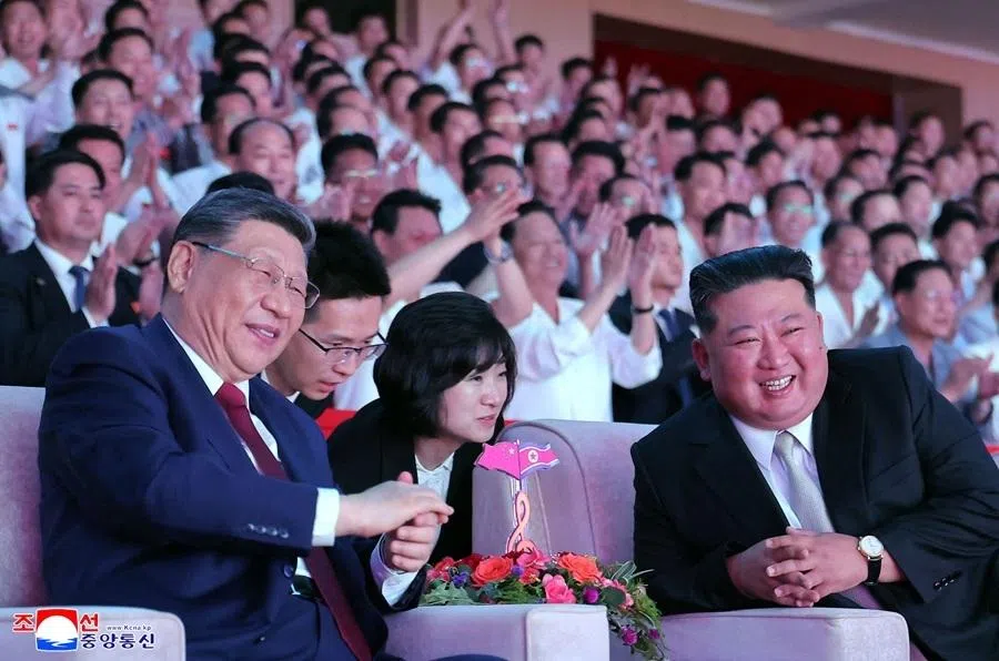 This picture taken on 8 June 2026 and released by North Korea's official Korean Central News Agency (KCNA) on 9 June 2026 shows North Korean leader Kim Jong Un (right) and China's President Xi Jinping watching a welcome performance at the Pyongyang Gymnasium.