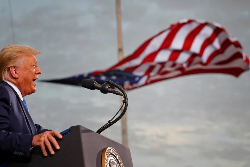 US President Donald Trump speaks, with a flag behind him, during a campaign rally at Cecil Airport in Jacksonville, Florida, US, 24 September 2020. (Tom Brenner/REUTERS)