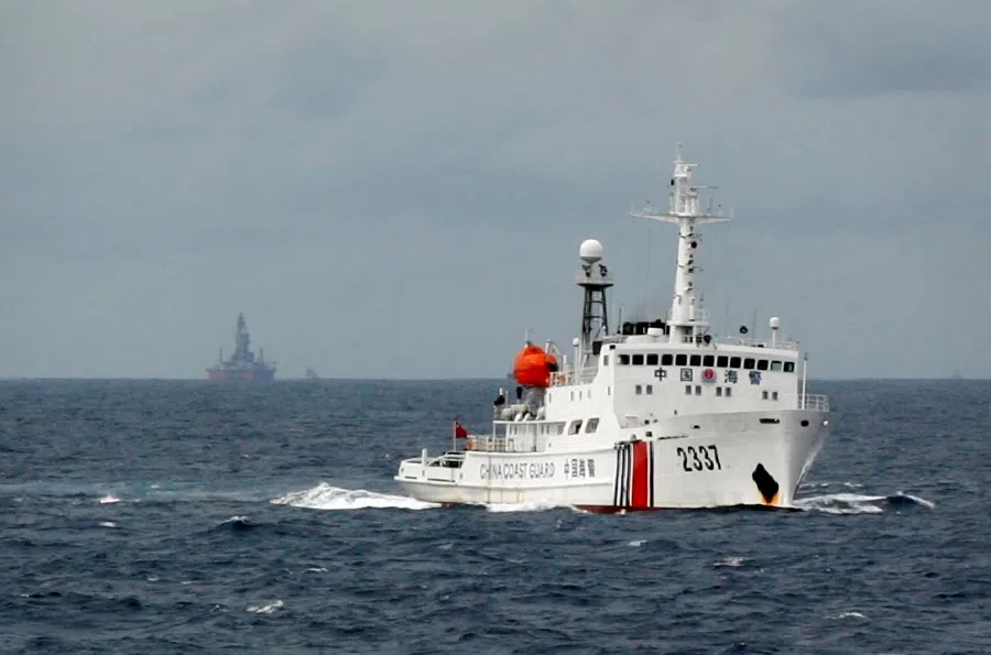 A Chinese Coast Guard vessel (right) passes in the South China Sea, 13 June 2014. (Nguyen Minh/Reuters)