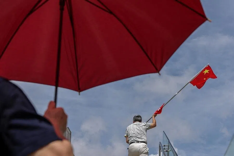 A man holds a Chinese national flag celebrating the 29th anniversary of the former British colony's handover to Chinese rule, in Hong Kong, China, on 1 July 2026.