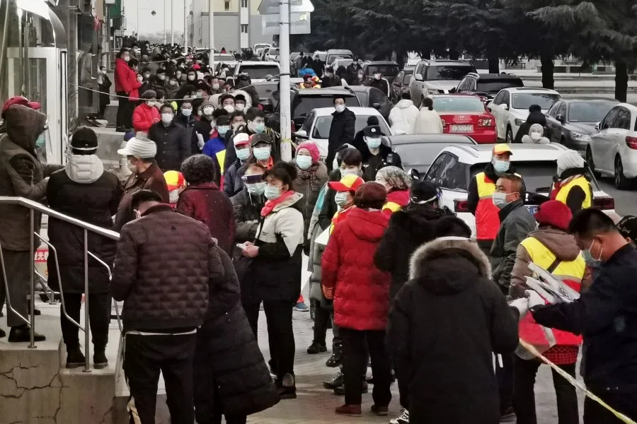 Residents wait to be tested for the Covid-19 coronavirus as the city carries out a mass testing program in Dalian, in northeastern China's Liaoning province on 22 December 2020. (STR/AFP)