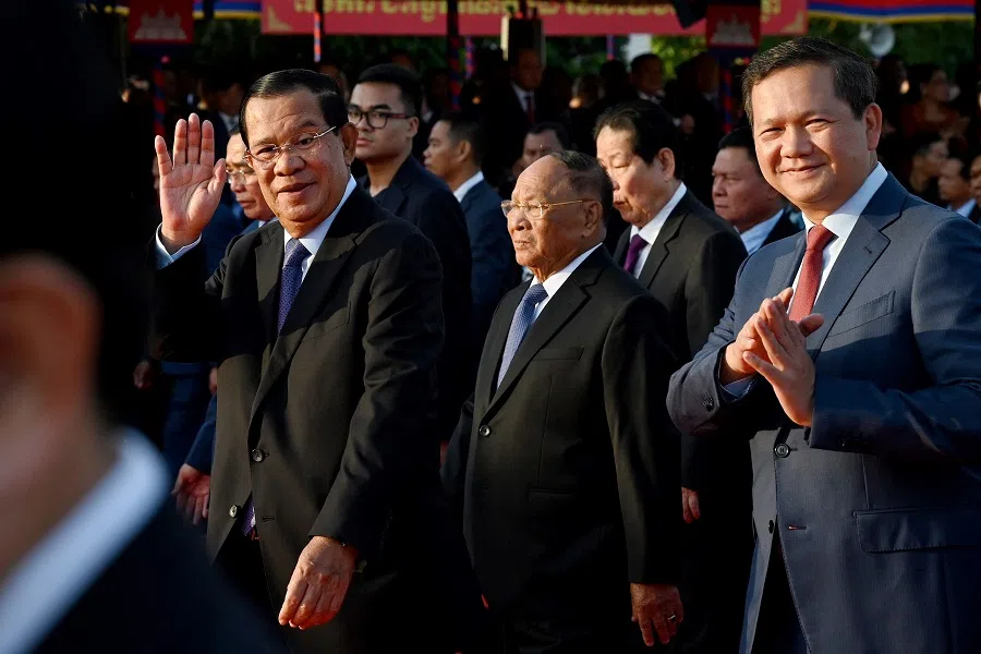 President of the Cambodian People’s Party (CPP) Hun Sen (left), Honorary President of the Cambodian People’s Party (CPP) Heng Samrin (centre) and Cambodia’s Prime Minister Hun Manet (right) greet supporters during a ceremony marking the 45th anniversary of the fall of the Khmer Rouge regime in Phnom Penh on 7 January 2024.