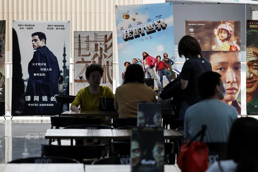People sit at tables while waiting for the showtime at a movie theatre in Shanghai, China, on 11 April 2025.
