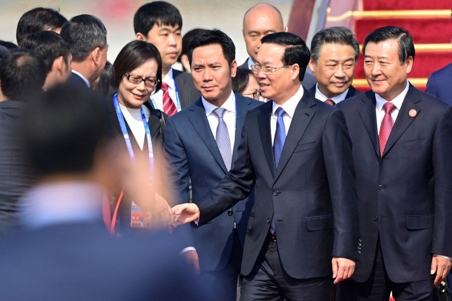 Vietnam's President Vo Van Thuong (in blue tie and spectacles) arrives at Beijing Capital International Airport ahead of the Belt and Road Forum in the Chinese capital on 17 October 2023. (Parker Song/AFP)