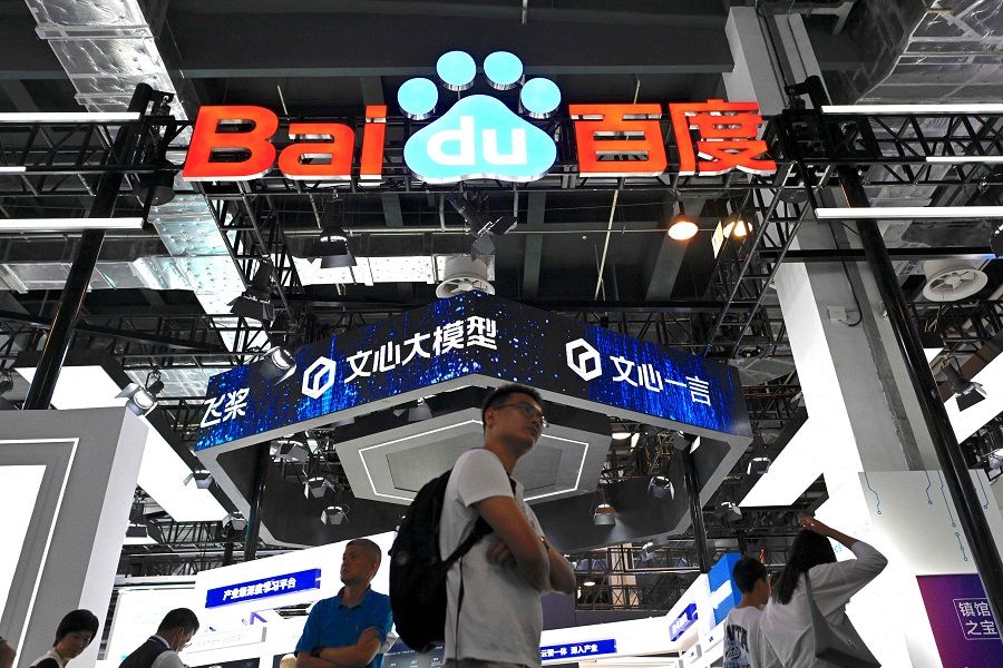 Visitors walk past the booth of Baidu during the World Artificial Intelligence Conference (WAIC) in Shanghai, China on 6 July 2023. (Wang Zhao/AFP)