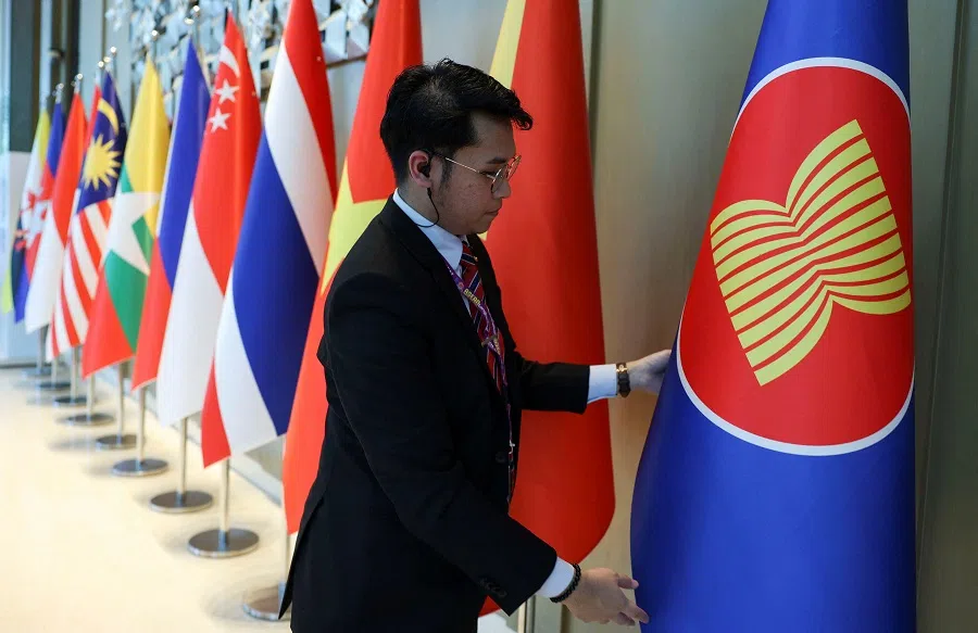 An officer arranges the ASEAN flag ahead of the ASEAN Foreign Ministers’ Retreat in Langkawi, Malaysia, on 17 January 2025.
