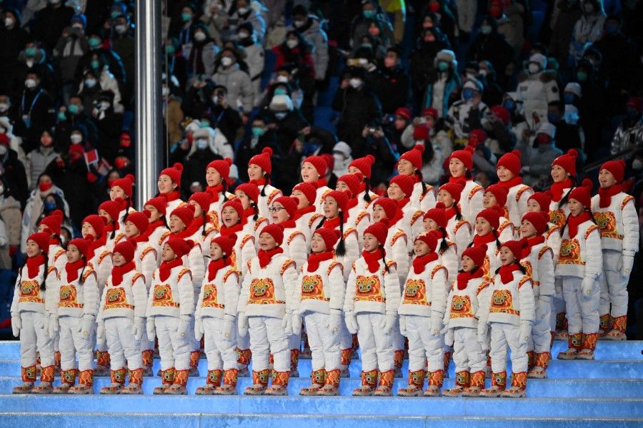 Young performers sing the Olympic anthem during the opening ceremony of the Beijing 2022 Winter Olympic Games, at the National Stadium, known as the Bird's Nest, in Beijing, on 4 February 2022. (Ben Stansall/AFP)