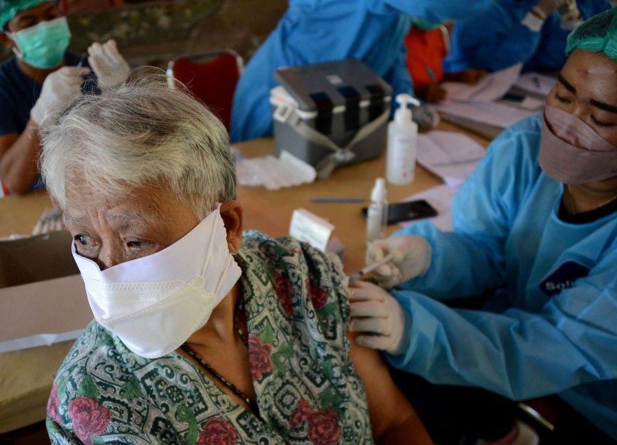 A woman receives the Sinovac Covid-19 coronavirus vaccine in Denpasar, Indonesia's Bali island on 2 September 2021. (Sonny Tumbelaka/AFP)