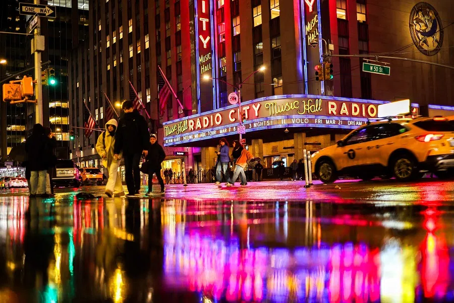 People walk in a street in the rain in the Manhattan borough of New York City on 31 January 2025. (Charly Triballeau/AFP)