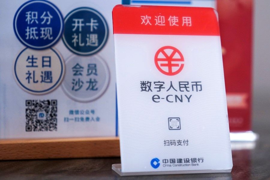 A sign indicating digital yuan, also referred to as e-CNY, is pictured at a shopping mall in Shanghai, China, 21 April 2021. (Aly Song/Reuters)