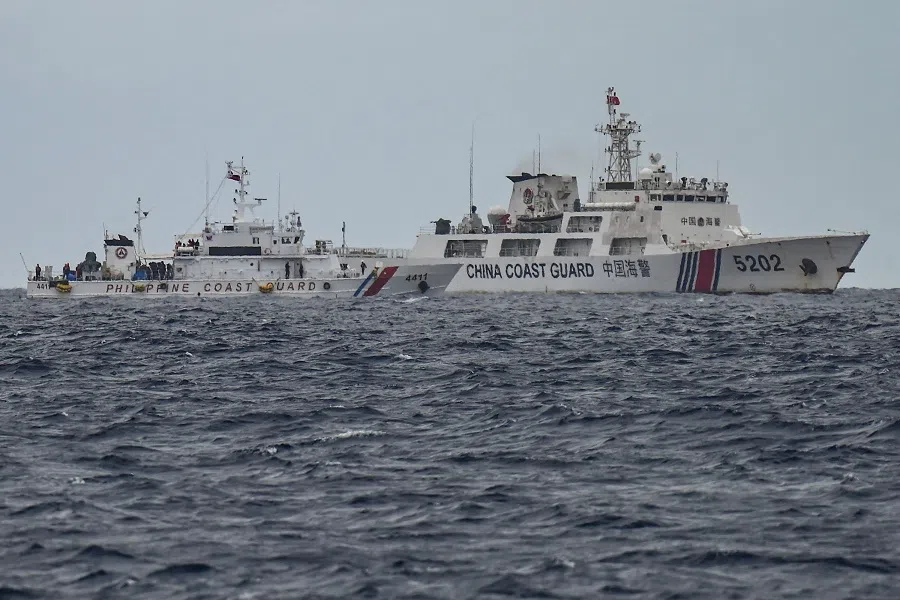 A China Coast Guard ship (right) is seen past the Philippine Coast Guard ship BRP Cape Engaño (left), as photographed from the BRP Cabra during a supply mission to Sabina Shoal, also known as Escoda Shoal, in disputed waters of the South China Sea on 26 August 2024. (Jam Sta Rosa/AFP)